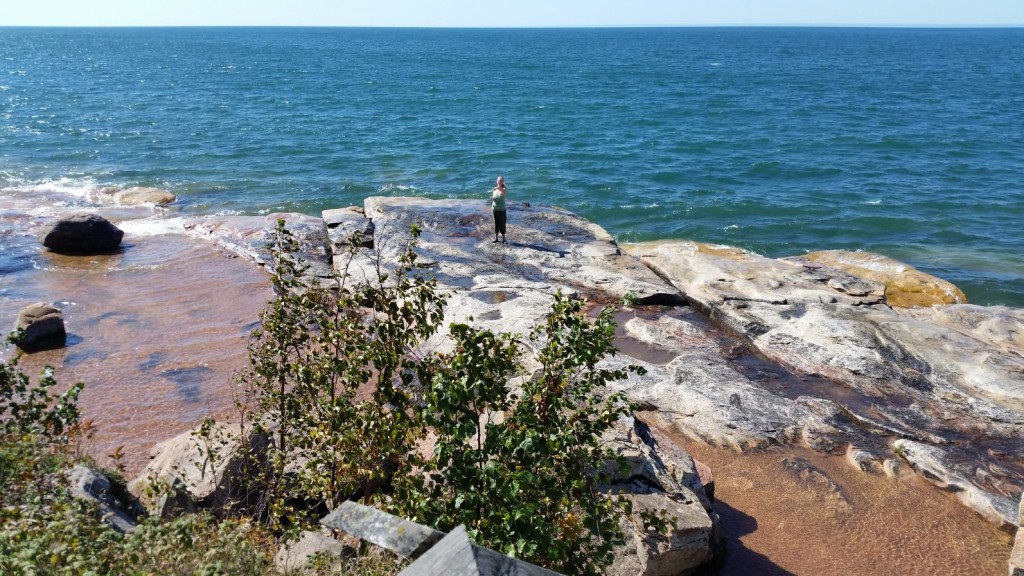 Jodi down by the water viewed from the Sand Island Lighthouse